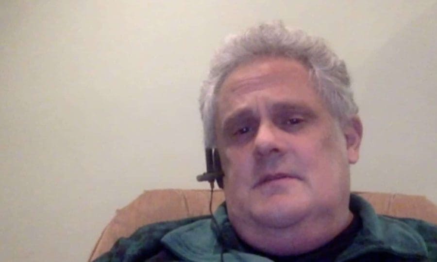 GCA man wearing headset sitting at home