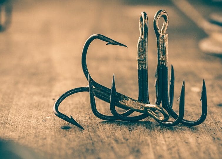 GCA pile of fish hooks sitting on floor