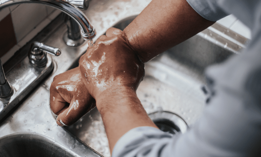 GCA man washing hands in sink