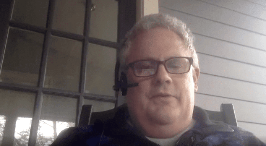GCA man wearing headset sitting on the porch