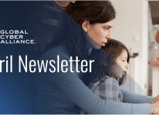 GCA April Newsletter woman working from home with child on her lap