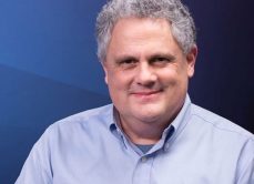 GCA Phil Headshot with varigated blue background