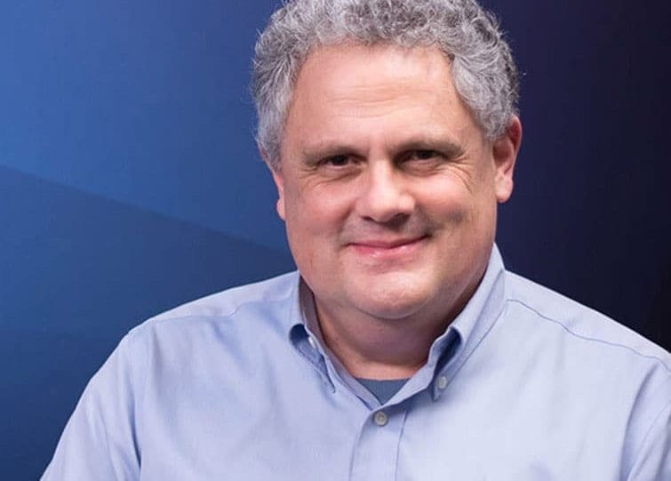 GCA Phil Headshot with varigated blue background