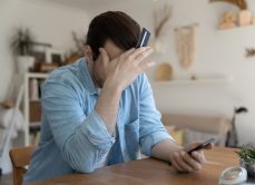 Consumer at laptop may have been scammed or attacked.