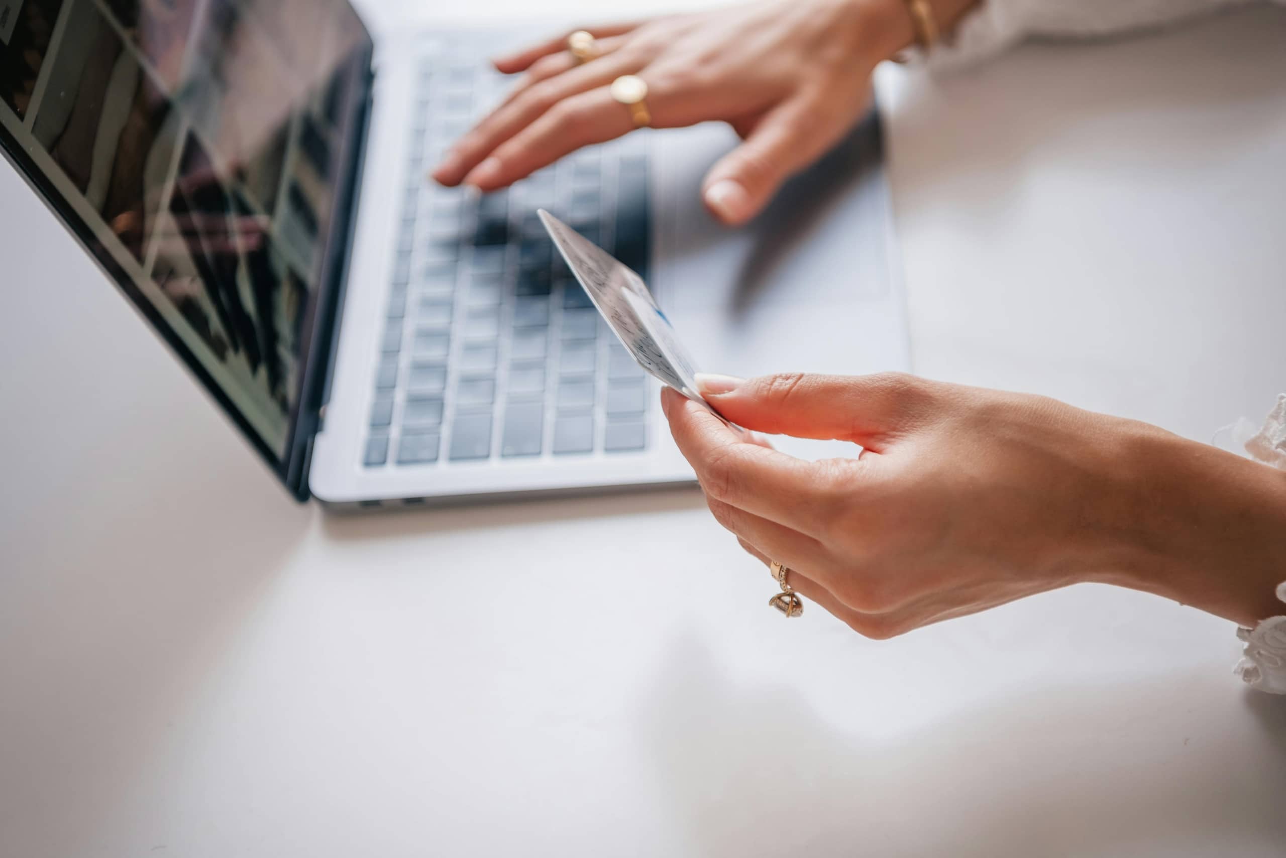 online shopping image credit card in hand at laptop