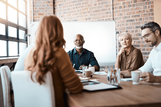Coworkers sitting at a table during a meeting.