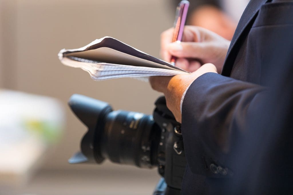 Journalist taking notes.
