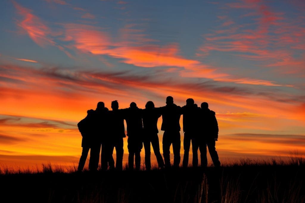 A group of people watching the sunset.