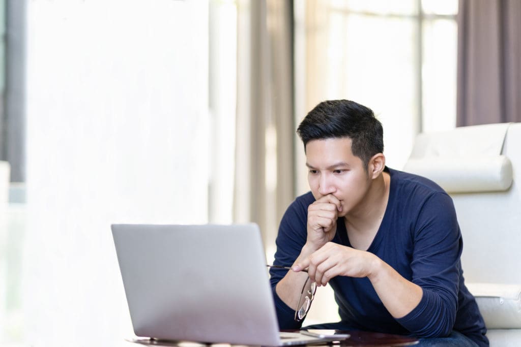 A person looking at their laptop.