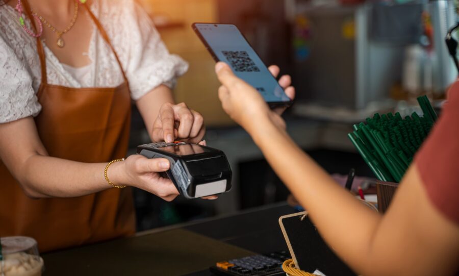 woman with cashpoint system at a small business