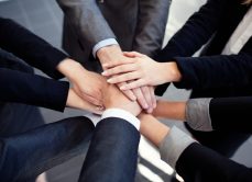 Business people huddle together to collaborate