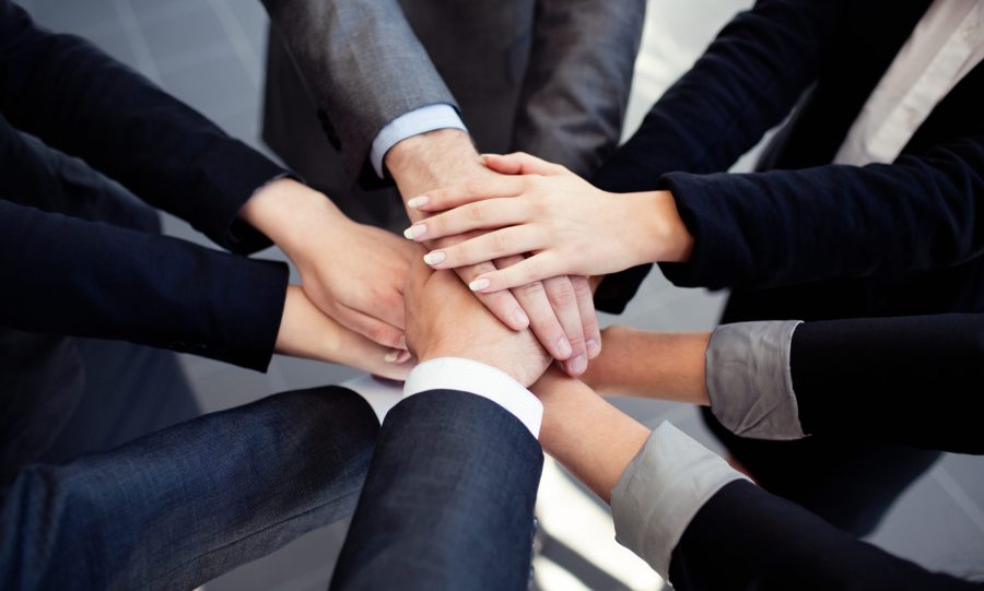 Business people huddle together to collaborate