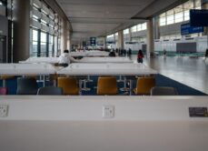 Workstations with charging ports and free WiFi at Shanghai Pudong International Airport. People use laptops and phones in coworking space while waiting for flights. 03 April 2025. Shanghai, China